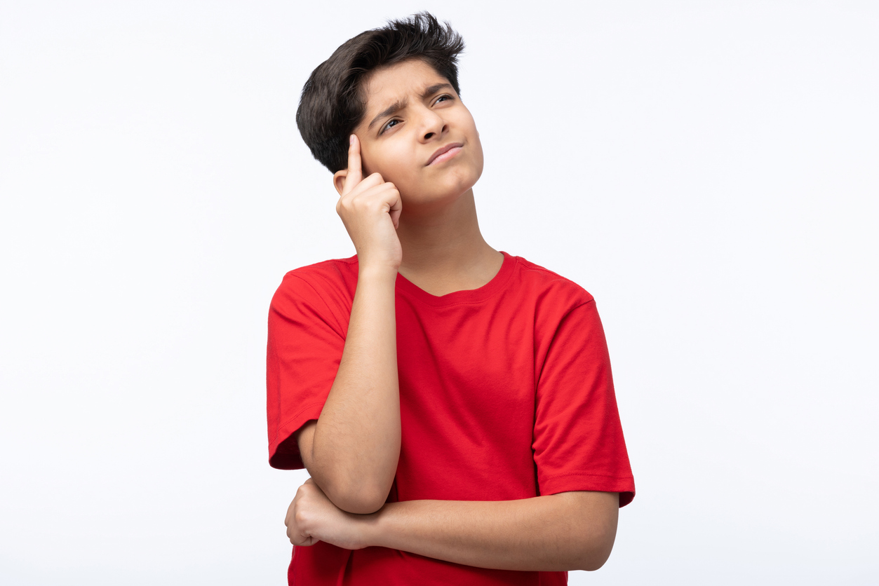 Teen looking up, trying to remember what they signed