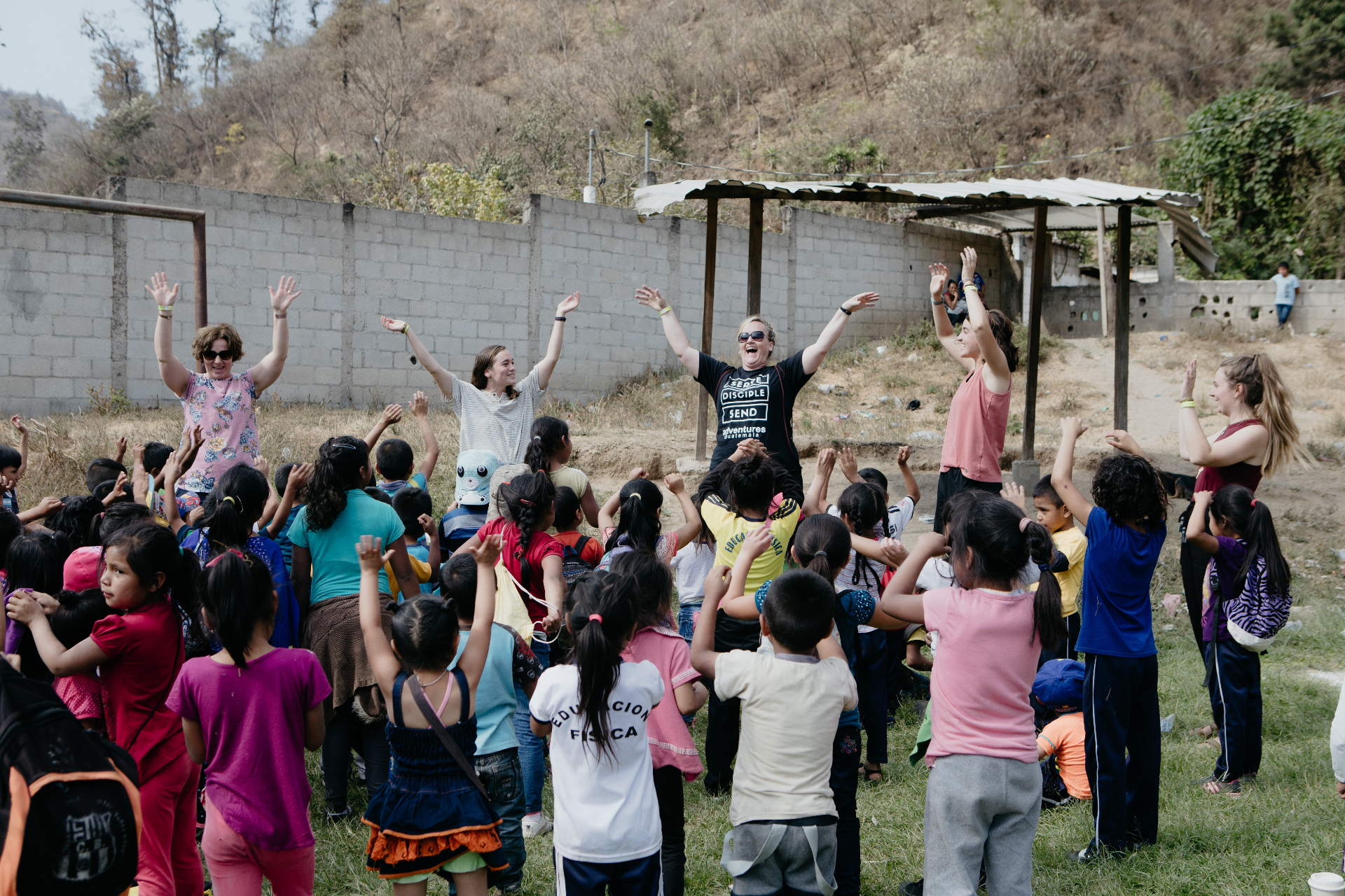 Parents and Racers leading worship and games with children at a CarePoint in Guatemala