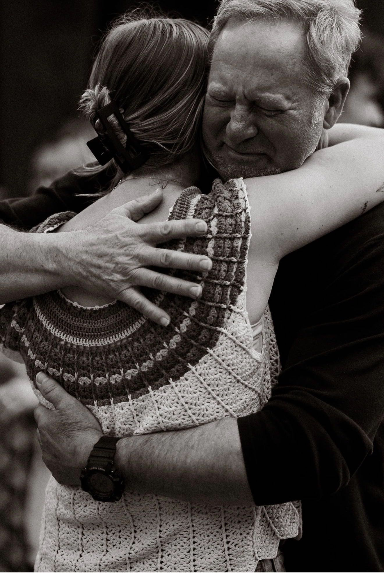 A father embracing his daughter with emotion during a Parent Ministry gathering