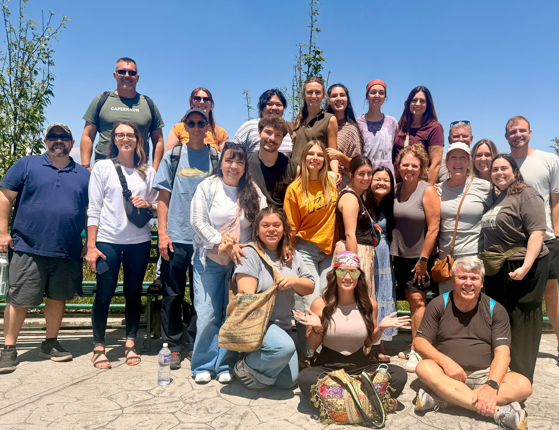 Parent Vision Trip group portrait in Nepal — parents, alumni, and Racers together on a sunlit overlook