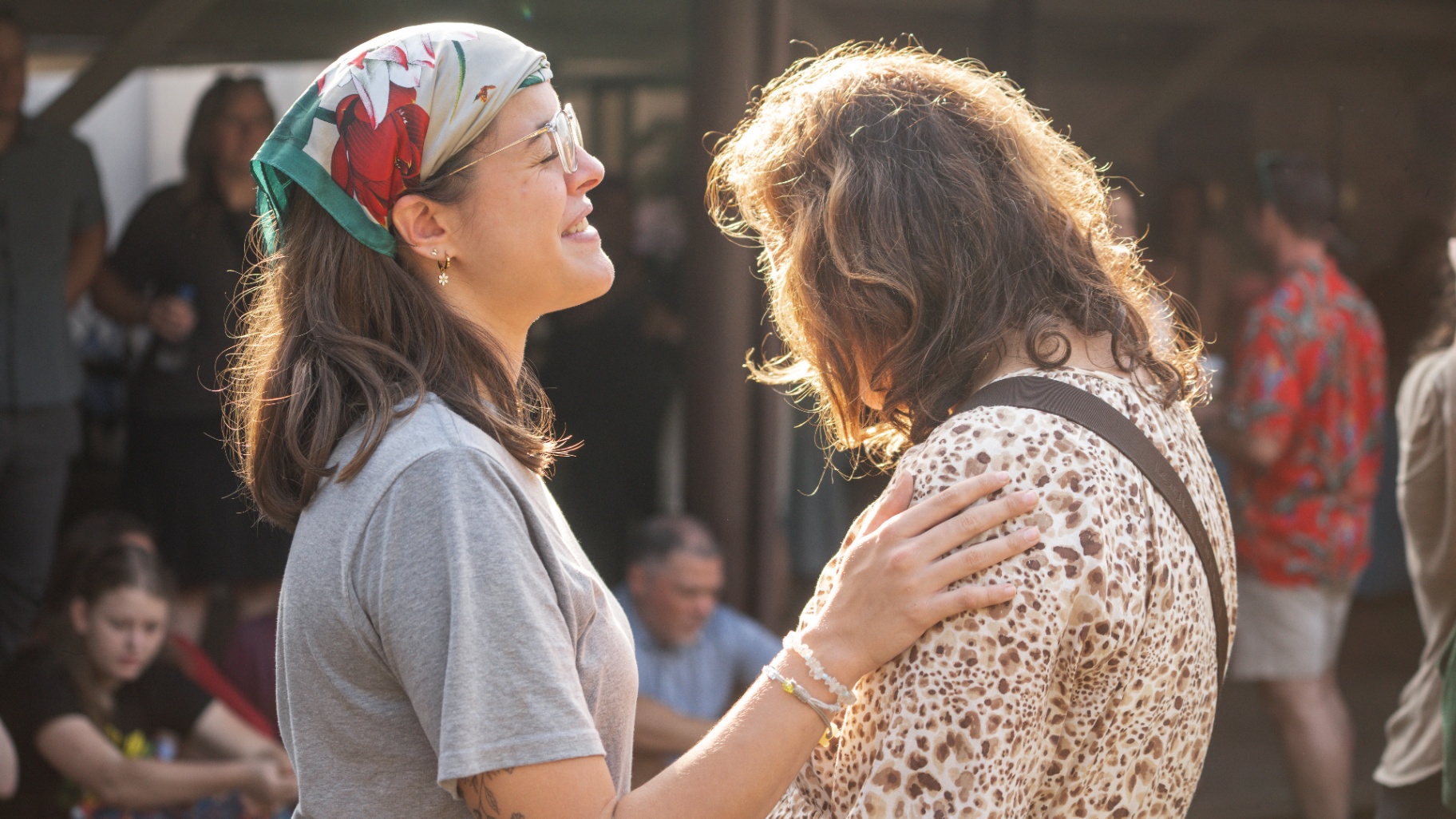 Two women embracing in golden sunlight