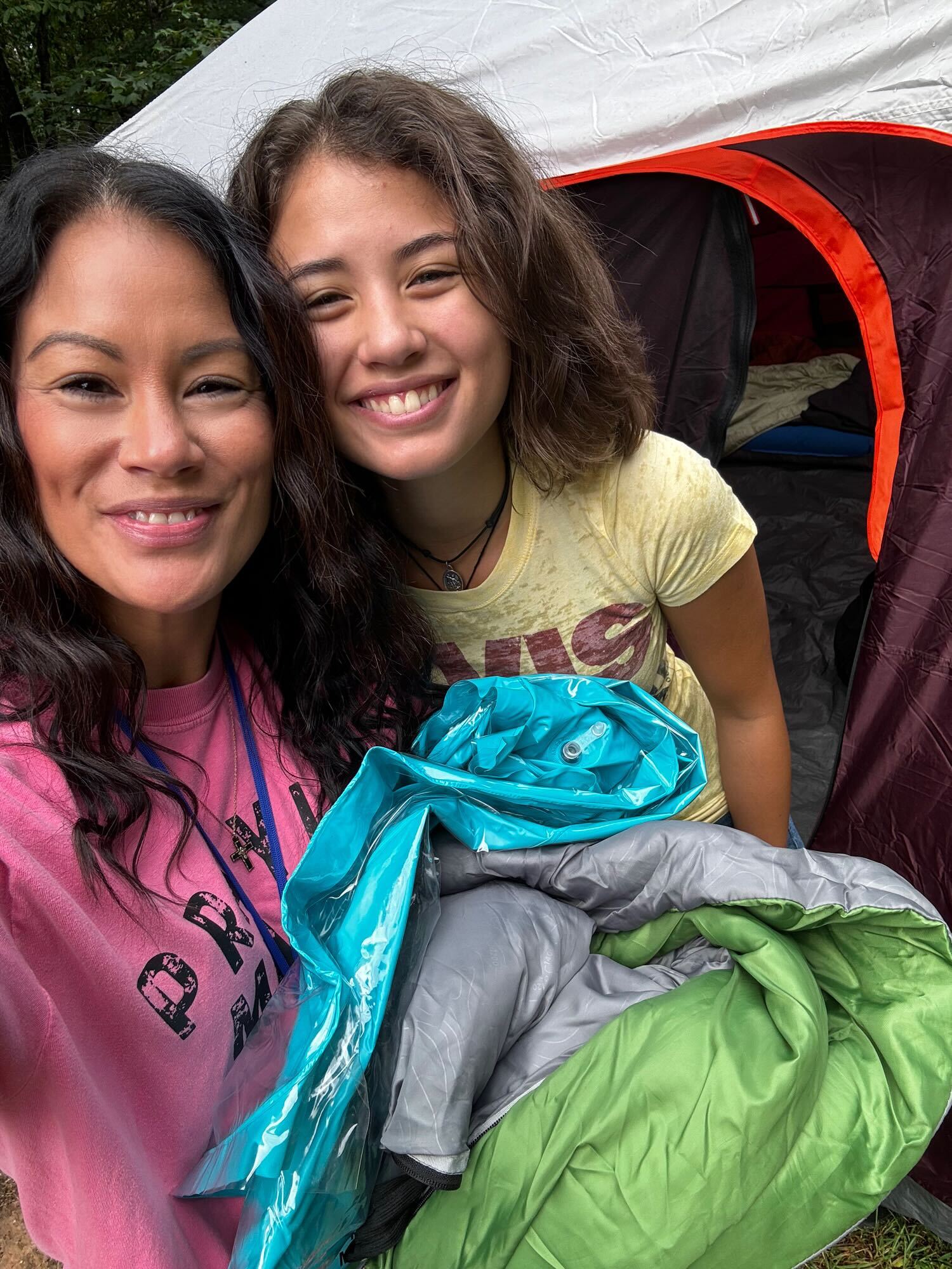 Noelle and Sophia smiling together at the tent on training camp